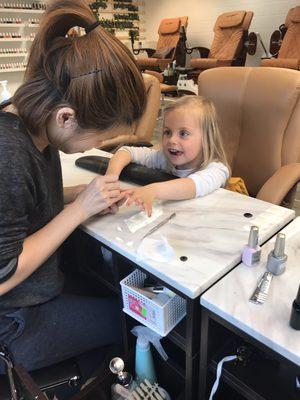 Our sweet little customer getting her nails done