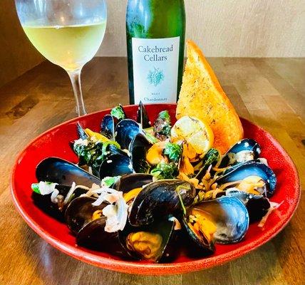 Special: mussels delicately cooked in a rich garlic herb butter sauce, accompanied by shallots, scallions, pickled ginger, and fresh spinach