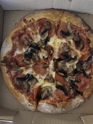 Small customized pizza with mushrooms,sausage and pepperoni