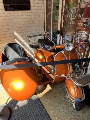 A  clean Vespa and side car is a homage to the one of the owner's best friend, surfer buddy-- Pudge the surfing bulldog (google him).