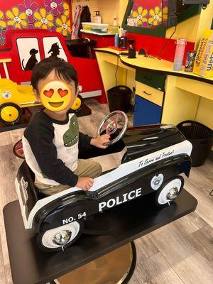 Before the haircut! My son loves the police car seat!