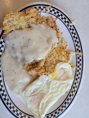 Chicken fried steak with gravy, eggs and home fries