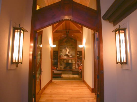 The heavy timber ceiling of the front porch continues through the foyer and greatroom culminating in the massive stone firepl...