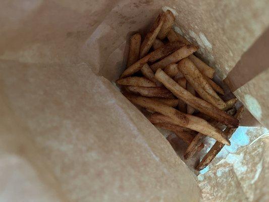 Seasoned fries in takeout bag.