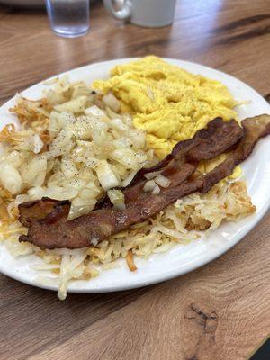 Scrambled eggs with hashbrowns, grilled onions and bacon.