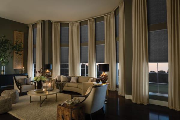 Keep heat in with double cell cellular shades and pinch pleat drapery panels.