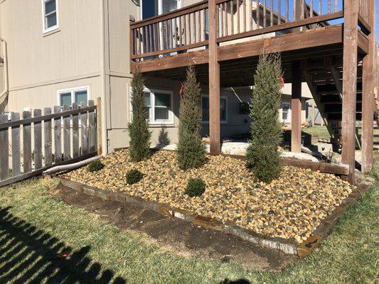 A beautifully landscaped area under the deck