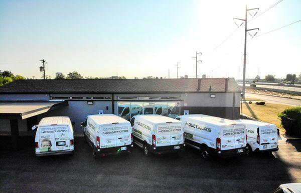 Outside our new building with our working Vans.