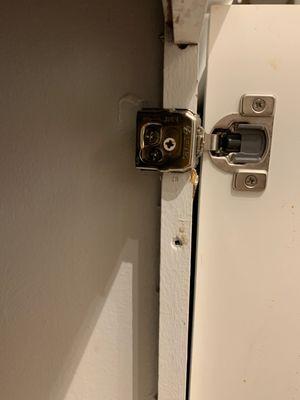 This hinge is literally holding the entire cabinet door on with one screw, the two other screws aren't actually attached.