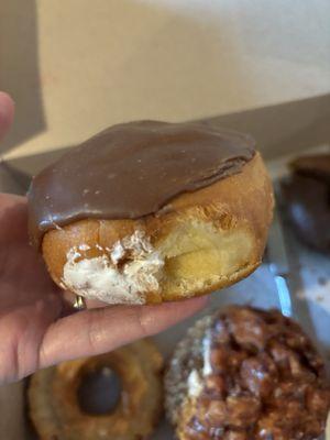 White cream filled, chocolate-iced donut