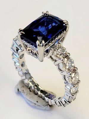 Custom made engagement ring by Three Crowns Jewelry. Sapphire set in graduated diamond eternity band in platinum.