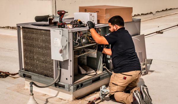 Lex Air Conditioning and Heating technician performing a fall maintenance check for a commercial client.