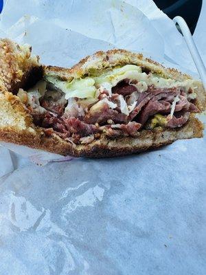 Half of my delicious pastrami sandwich. Sorry I had to take a bite.