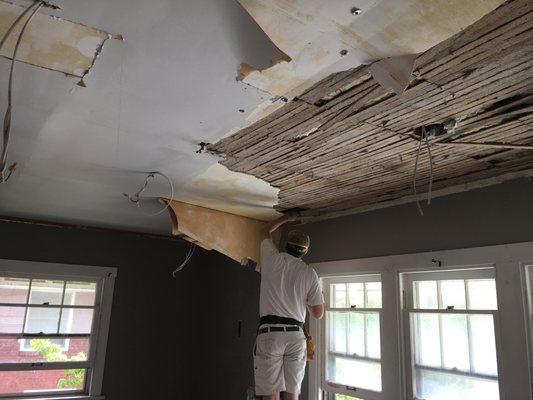 Ripping out a plaster ceiling.