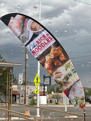 Look for the flag. Food truck is just behind Elegant Nails.