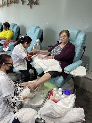 Pedi mani simultaneously.  Mom chilling and happy.