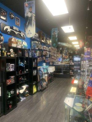 Inside of the store with the wall of figurines and posters