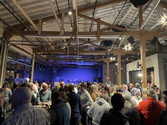 Lower level indoors with a band on stage