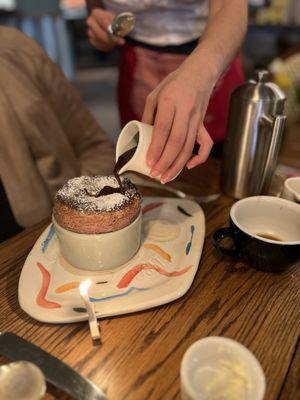 Pouring chocolate on the soufflé