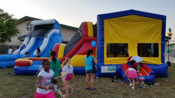 Tsunami Water slide and Covered Combo Bounce House at the Gator Glow Event at Gattis Elementary