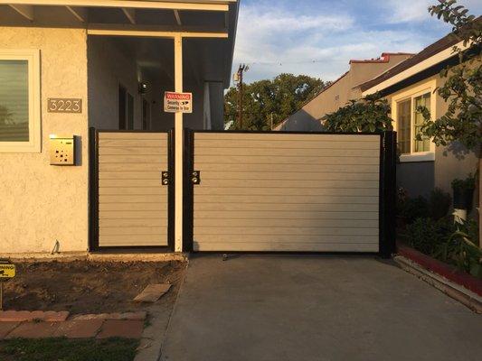 Iron swing and pedestrian gate with wood, deadbolt locks, knobs, sandblasted, primered, and powder coated flat black