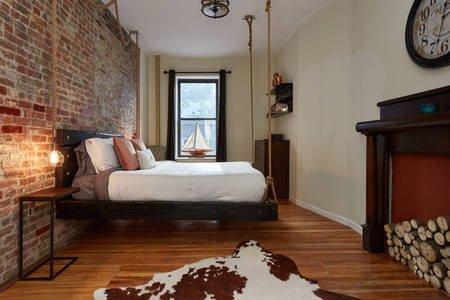 Expose brick, custom bed suspended by rope. Re-finish floors