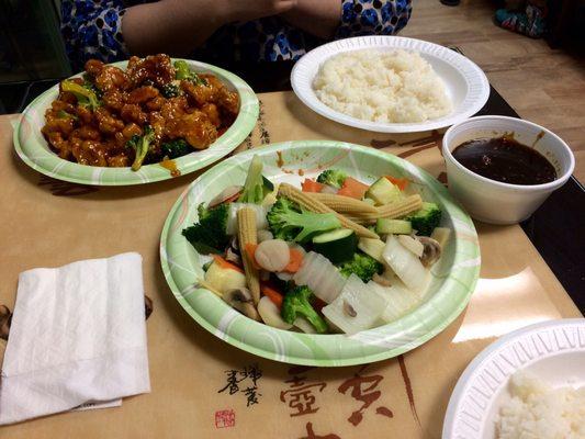 Mixed vegetables, sesame chicken, and rice.