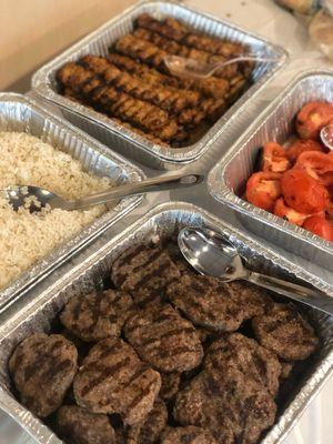 Rice, Chicken Adana Kebab, Barbecued Meatballs, and Grilled Tomatoes.