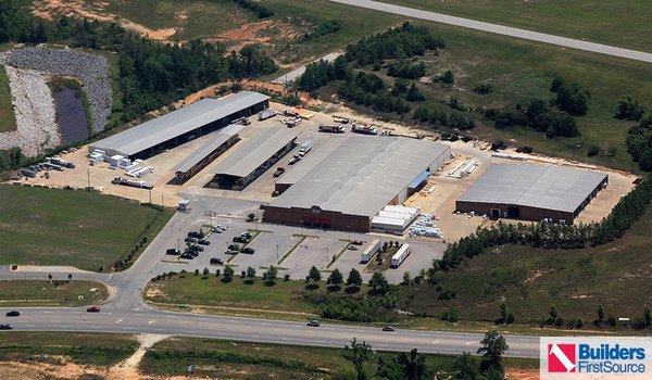 Building materials supplier Builders FirstSource's forklift is moving wood roof trusses.