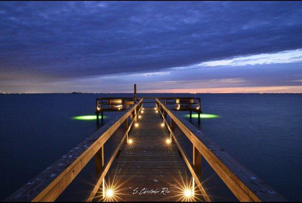 The pier is lit with lights and at the end of it are green lights where you can fish all night.