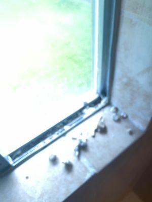 Master bath shower. Construction screws and grout. There was so much debris in the window runner that the window wouldn't even open