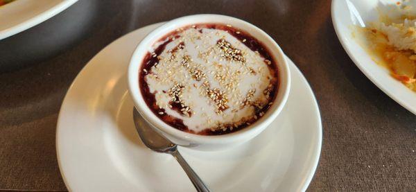 Black rice & coconut milk with sesame seeds sprinkled on top.