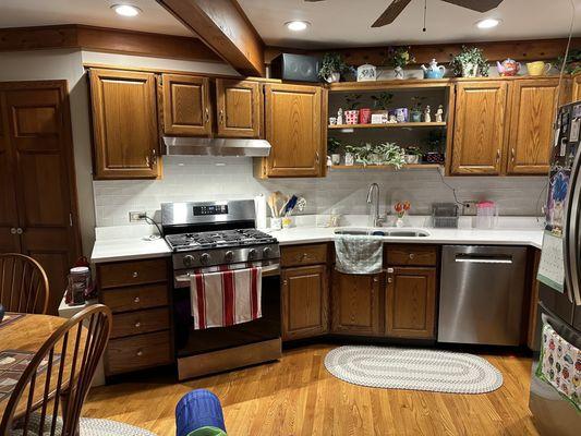 Shot showing most of the kitchen and close up to show tile/counter