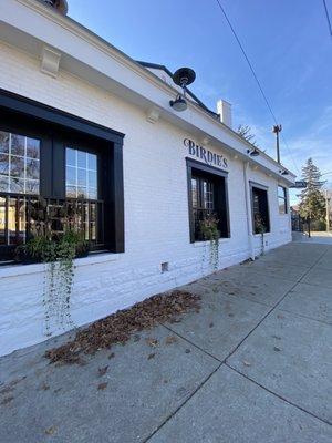 Outside the side of the building, entrance is on the corner facing the street