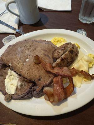 Blueberry pancakes with eggs and sausage