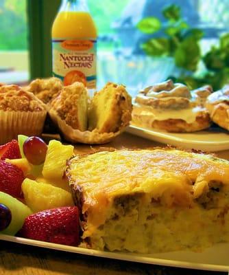 Egg casserole with fresh fruit and freshly baked morning pastries.