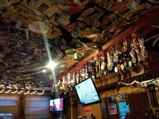 Tap handle display with signed currency on the ceiling.