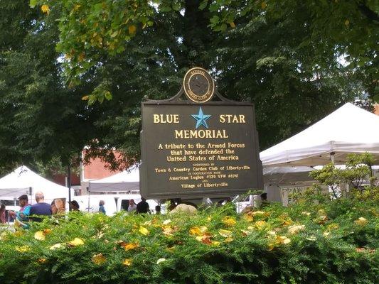 Blue Star Memorial Sign in front of the tents in the Farmers Market