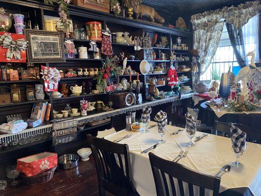 One of the restaurant tables and shelves with knickknacks (many of which are for sale).