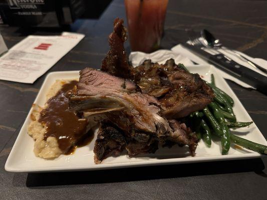 Half rack of bbq ribs with mashed potatoes and green beans