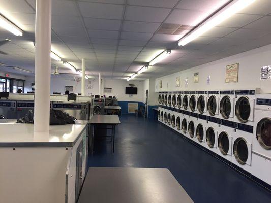 Row of dryers on the right washers on the left, small medium and large.