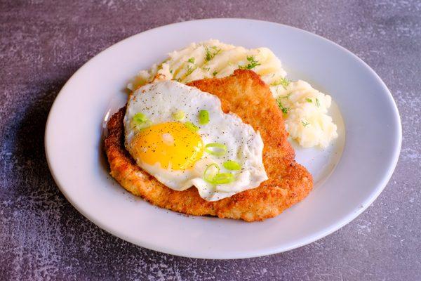 Traditional Polish Breaded Pork Cutlet, served with fried egg, side salad and mashed potatoes.