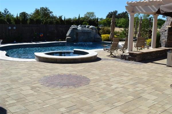 Turn your backyard into a breathtaking oasis by doing hardscape paving stones around the pool.