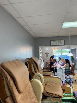 More nail techs than needed ready to work. Lisa is a nail goddess. They have new chairs for massages.