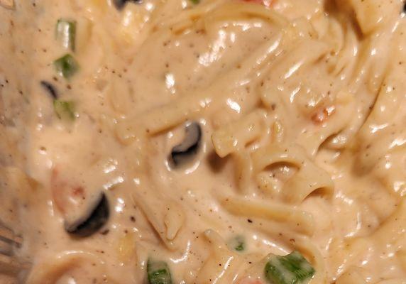 Fettuccini. Noodles boiled to perfection in a wonderfully smooth white sauce .Fresh  Green peppers-onions-black olives and real butter.