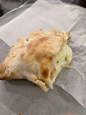 Half a calzone to show the cheese filling