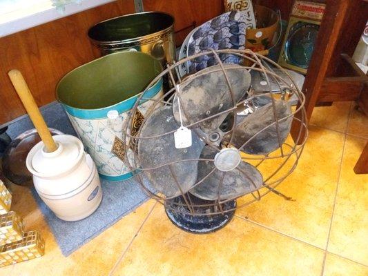 Vintage metal wastebaskets,antique fan, butter churn.