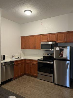 Full size kitchen with dishes, utensils and glassware.