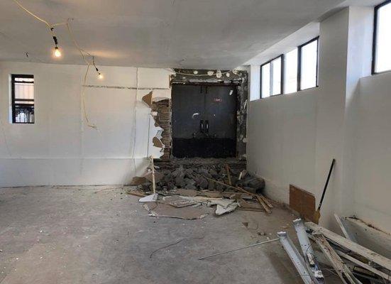 Demolition of a wall to expose a covered up door