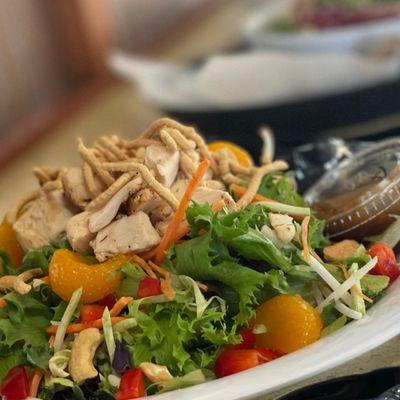 Asian Chicken salad:
 Super greens, roasted all-natural chicken breast, mandarin oranges, cucumbers, red peppers, peanuts and crispy noodles